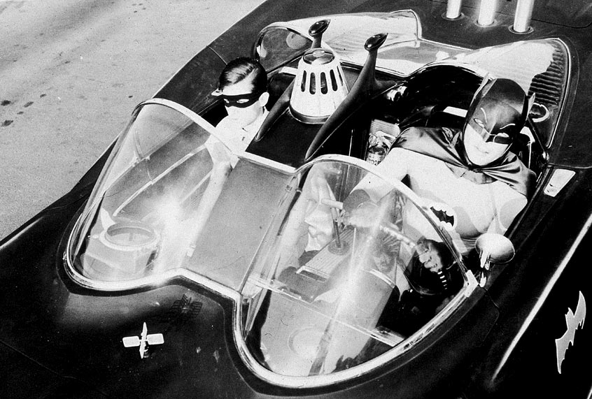 Burt Ward as Robin and Adam West as Batman ride in the Batmobile in a still from "Batman." (20th Century Fox/Courtesy of Getty Images)