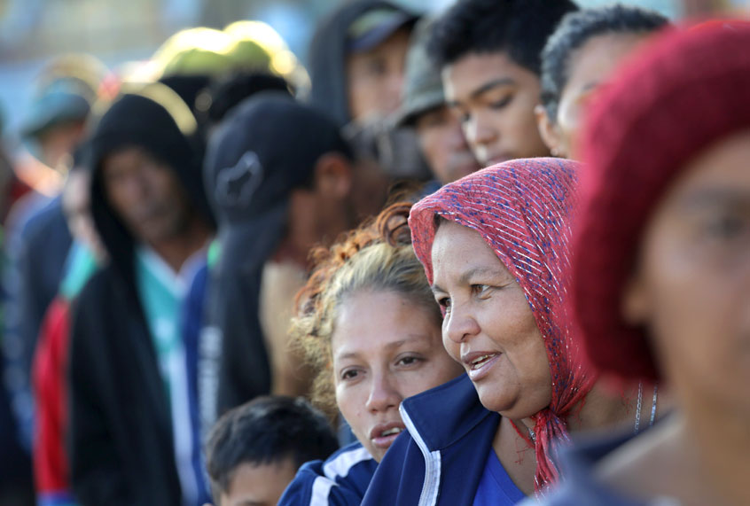 Members of the migrant caravan wait in line to turn in requests for political asylum at the U.S.-Mexico border on November 17, 2018 in Tijuana, Mexico (Getty/John Moore)