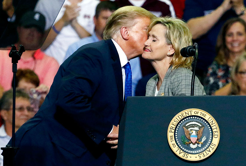 Donald Trump kisses U.S. Sen. Cindy Hyde-Smith, R-Miss., after introducing her at a rally in Southaven, Miss. (AP/Rogelio V. Solis)