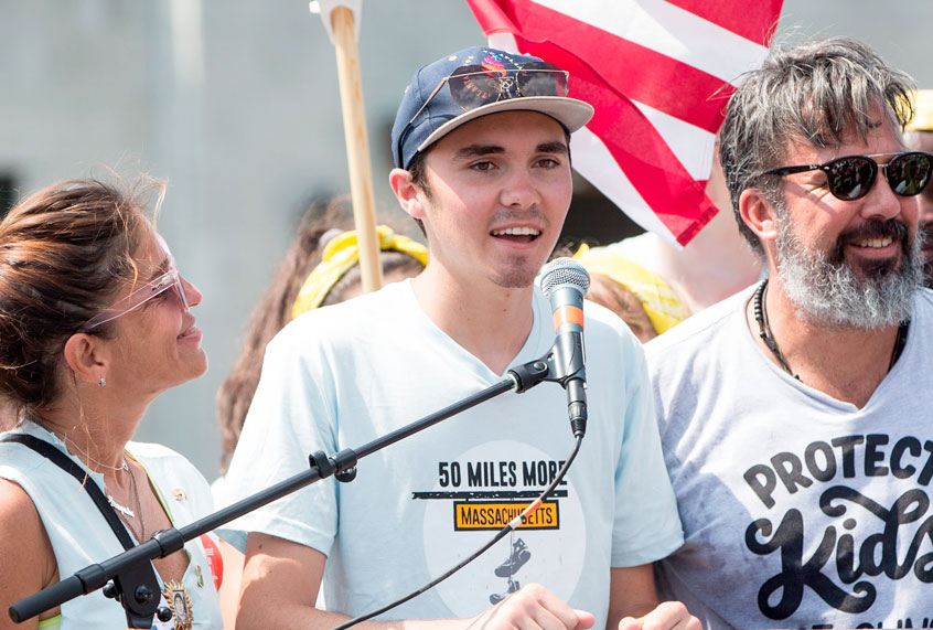 Parkland shooting victim and survior David Hogg; center, joins Manuel Oliver and his wife Patricia Oliver, parents of Parkland shooting victim Joaquin Oliver, and other members of the 50 Miles More walk against gun violence rally at the end of their walk on August 26, 2018 in Springfield, Massachusetts. (Getty/Scott Eisen)