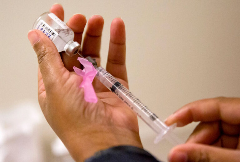 A nurse prepares a flu shot. (AP/David Goldman)