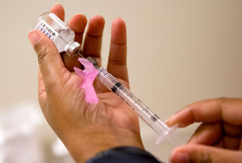 A nurse prepares a flu shot. (AP/David Goldman)