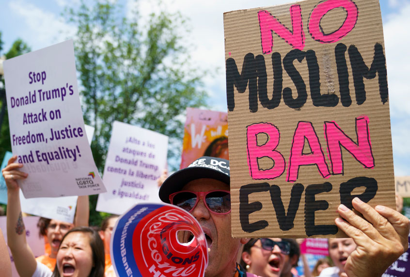 Protesters call out against the Supreme Court ruling upholding President Donald Trump's travel ban outside the Supreme Court on Capitol Hill in in Washington, Tuesday, June 26, 2018. (AP/Carolyn Kaster)