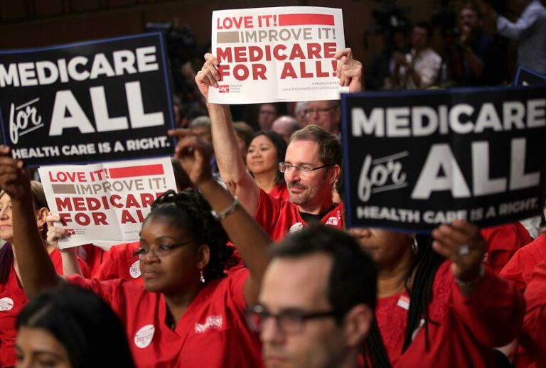Supporters of U.S. Sen. Bernie Sanders hold signs during an event on health care. (Getty/Alex Wong)