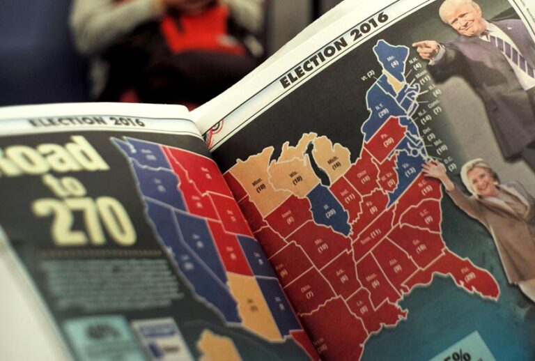 A subway commuter reads a newspaper featuring the US election results in New York on November 9, 2016. (Getty/Jewel Samad)