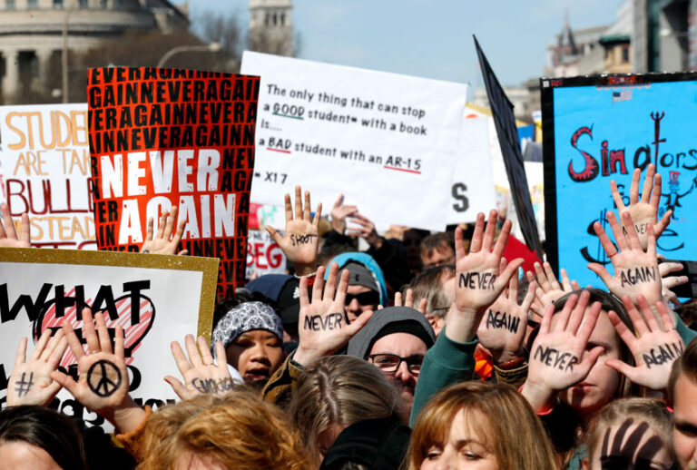 People hold their hands up with messages written on them during the "March for Our Lives" rally in support of gun control, Saturday, March 24, 2018, in Washington. (AP/Alex Brandon)