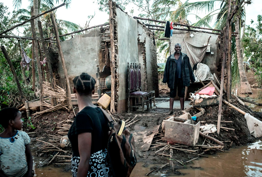 Joaninha Manuel, 9, and her sister Rosita Moises Zacarias, 15, look at their father Francisco Simon in their house destroyed by the cyclone Idai as they go to seep in a shelter in Buzi, Mozambique, on March 22, 2019. (Getty/Yasuyoshi Chiba)
