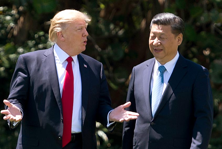 Donald Trump and Chinese President Xi Jinping walk together at the Mar-a-Lago estate in West Palm Beach, Florida, April 7, 2017. (Getty/Jim Watson)