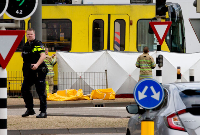 Rescue workers install a screen on the spot where a body was covered with a white blanket following a shooting in Utrecht, Netherlands, Monday, March 18, 2019. (AP/Peter Dejong)