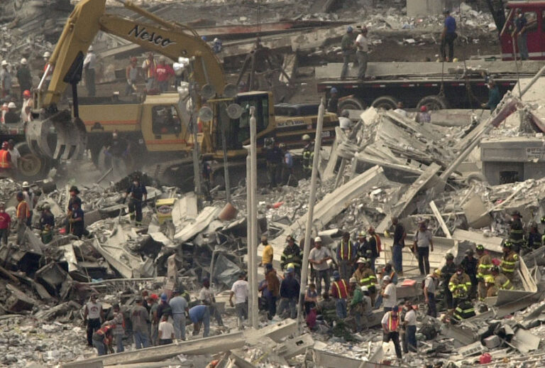 Emergency personnel work in the debris of the World Trade Center in New York, Wednesday, Sept. 12, 2001. (AP/Lawrence Jackson)