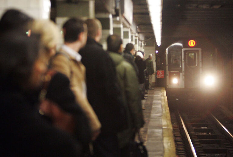 Commuters wait on the platform as a train arrives in the 23rd Street subway station. (Mario Tama/Getty Images)