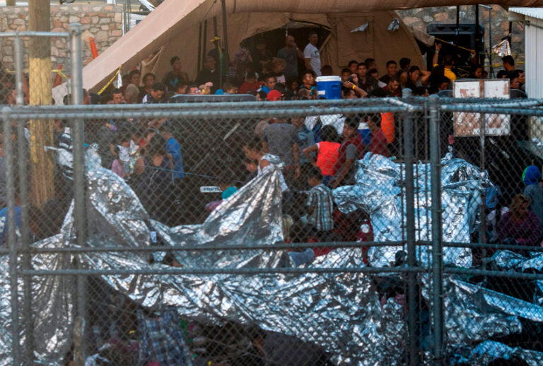 Migrants detained by US Customs and Border Protection are pictured in a makeshift holding facility beneath 'Paso Del Norte' bridge, between downtown El Paso and Ciudad Juarez, Mexico, as seen from El Paso, Texas, on April 19, 2019. (Getty/Paul Ratje)