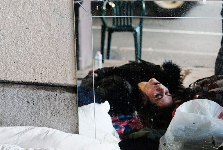A woman, passed out on heroin, is reflected in a mirror under a bridge where she lives with other addicts in the Kensington section which has become a hub for heroin use on January 24, 2018 in Philadelphia, Pennsylvania. (Getty/Spencer Platt)
