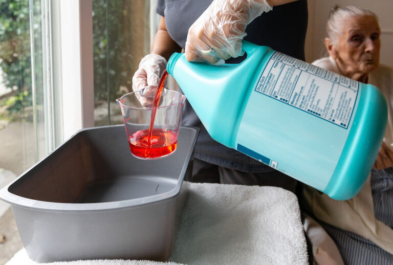 Certified nursing assistant Cristina Zainos prepares a special wash using antimicrobial soap. (Heidi De Marco/KHN)