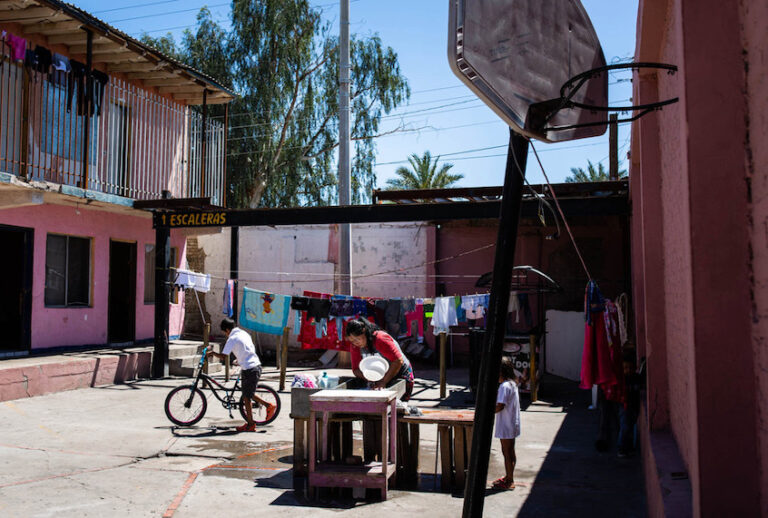 Tania (not her real name) washes clothes at a shelter in Mexicali where she stayed with her family for several weeks, first waiting to apply for asylum, and then waiting for a court hearing. A week after this photo was taken, she fainted in the heat and was hospitalized. (Anna Maria Barry-Jester/Kaiser Health News) (Anna Maria Barry-Jester/Kaiser Health News)