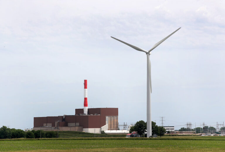 A power generating windmill towers above a nuclear power plant operated by Exelon on June 14, 2018 near Marseilles, Illinois (Scott Olson/Getty Images)