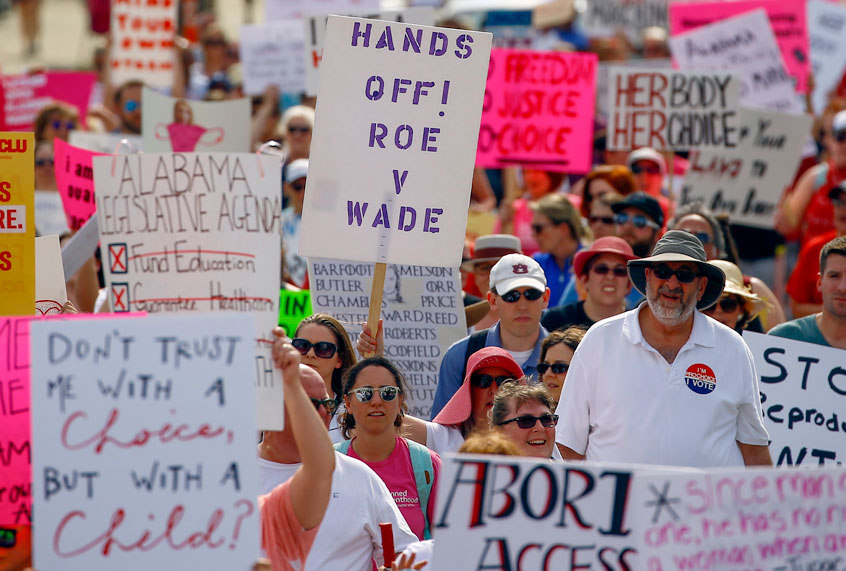 Protesters for women's rights march to the Alabama Capitol to protest a law passed last week making abortion a felony in nearly all cases with no exceptions for cases of rape or incest, Sunday, May 19, 2019, in Montgomery, Ala. (AP/Butch Dill)