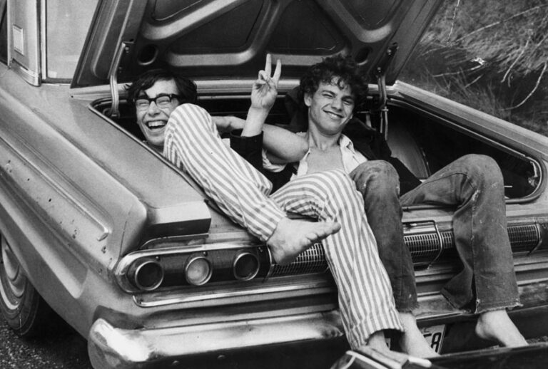 Two young men in the boot of a car after hitching a lift home from the Woodstock Music and Arts Fair, August 1969. (Getty Images/Three Lions)