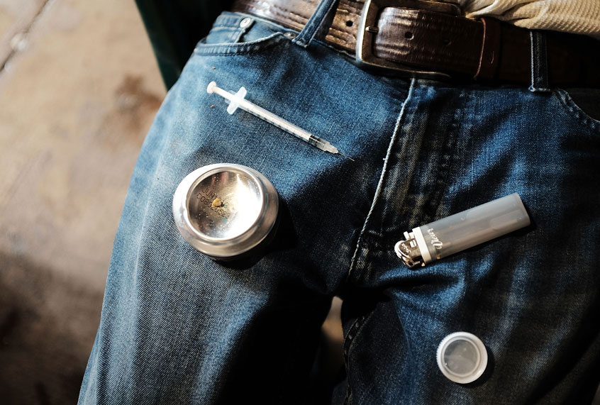 A man uses heroin under a bridge where he lives with other addicts in the Kensington section of Philadelphia which has become a hub for heroin use on January 24, 2018 in Philadelphia, Pennsylvania (Getty/Spencer Platt)