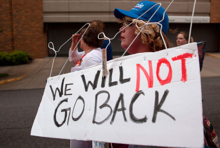Pro-Choice protesters with metal hangers on a sign march through the streets of Birmingham, Alabama, during the March For Reproductive Freedom on May 19, 2019. (Getty/Seth Herald)