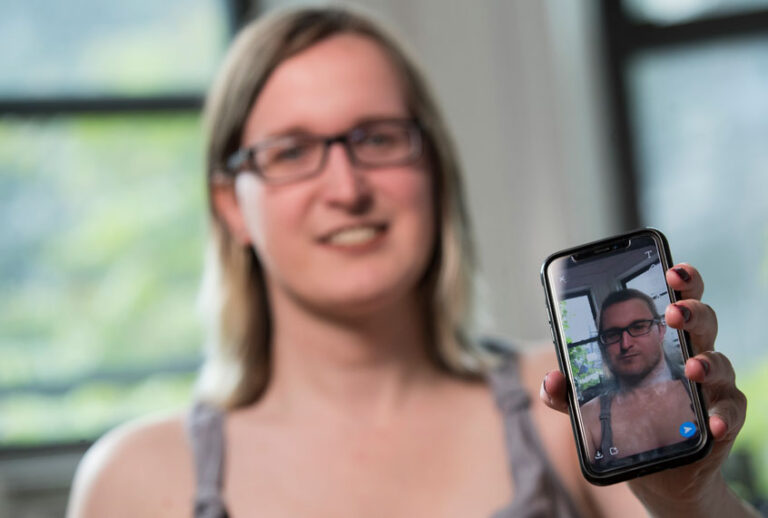 In this Wednesday, May 15, 2019, photo, Bailey Coffman shows her photo as a man in the Snapchat app during an interview in New York. (AP/Mary Altaffer)