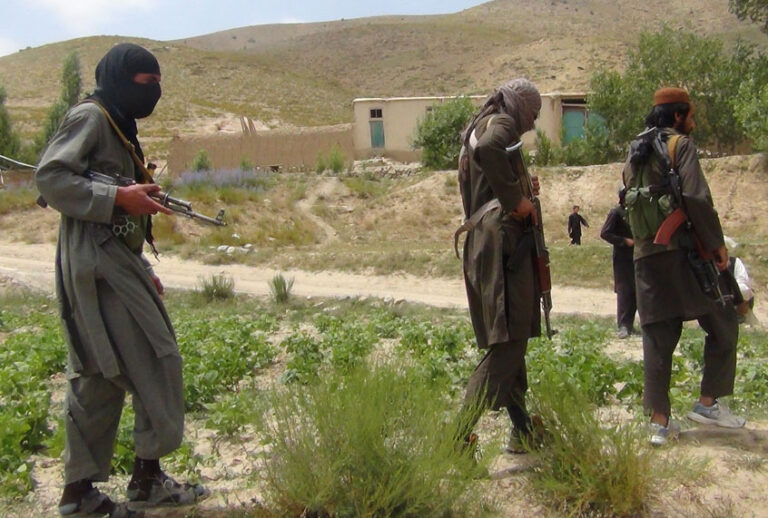 Fighters with Afghanistan's Taliban militia walk with their weapons in Ahmad Aba district on the outskirts of Gardez, the capital of Paktia province, on July 18, 2017. (Getty/FARIDULLAH AHMADZAI)