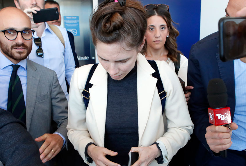 Amanda Knox, center, is approached by journalists upon her arrival in Linate airport, Milan, Italy, Thursday, June 13, 2019. (AP/Antonio Calanni)