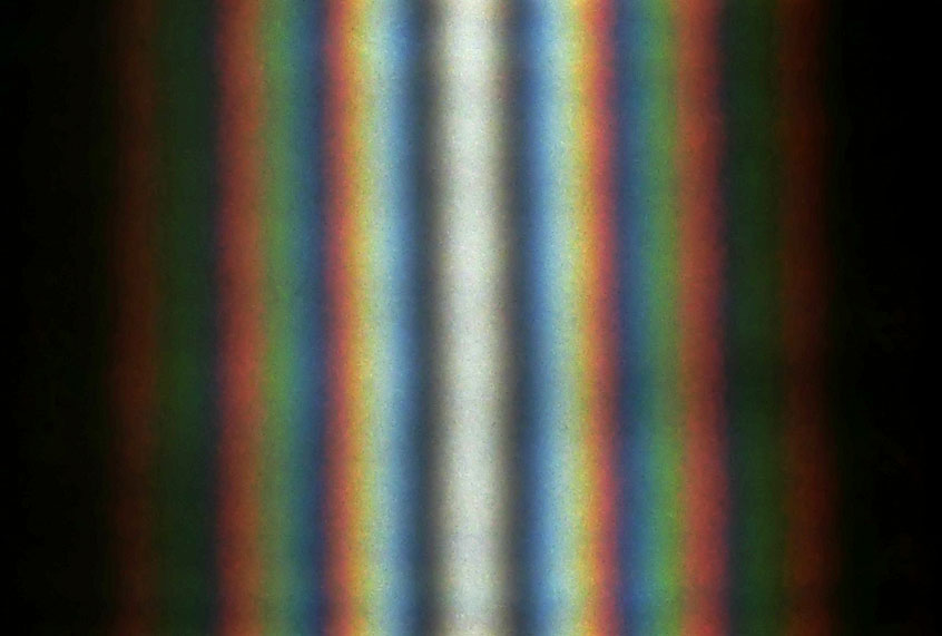 A double-slit interference of the sunlight passing through two slits ~1 cm long and ~0.5 mm apart. (Wikimedia/Aleksandr Berdnikov)