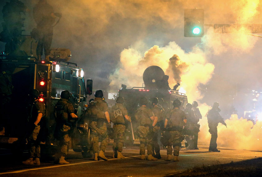 Police attempt to control demonstrators protesting the killing of teenager Michael Brown on August 18, 2014 in Ferguson, Missouri. (Getty/Scott Olson)