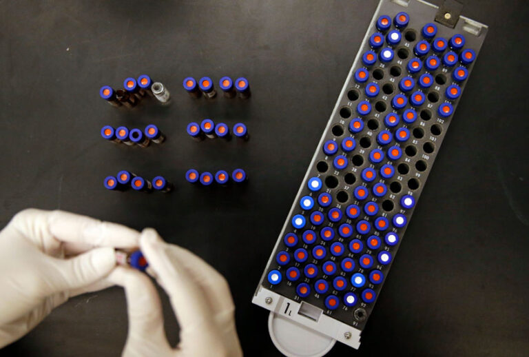 Christine Jelinek, a postdoctoral fellow at Johns Hopkins University, works alongside a tray of vials containing cerebral spinal fluid in Baltimore. Dr. Akhilesh Pandey, a researcher at Johns Hopkins University, said his research analyzes both adult and fetal tissue, and by identifying which proteins are present, he can get clues that could be used to help detect cancer in adults earlier. (AP/Patrick Semansky)