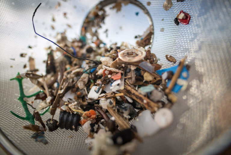 A volunteer of the NGO 'Canarias Libre de Plasticos' (Canary Islands free of plastics) carries out a collection of microplastics and mesoplastic debris to clean the Almaciga Beach, on the north coast of the Canary Island of Tenerife, on July 14, 2018. (Desiree Martin/Getty Images)