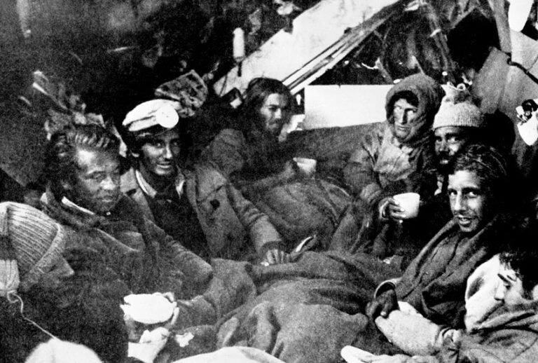 The last eight survivors of the Uruguayan Air Force plane crash in the Andes in South America, huddle together in the craft's fuselage on their final night before rescue on Dec. 22, 1972. (AP Photo)