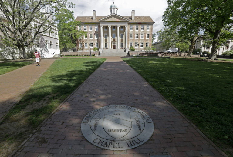 In this photo taken Monday, April 20, 2015 a sidewalk leads to the South Building on campus at The University of North Carolina in Chapel Hill, N.C. (AP Photo/Gerry Broome) (AP Photo/Gerry Broome)