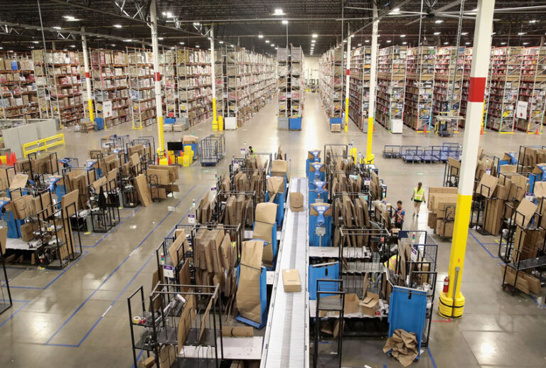 Workers pack and ship customer orders at the 750,000-square-foot Amazon fulfillment center on August 1, 2017 in Romeoville, Illinois. (Getty/Scott Olson)