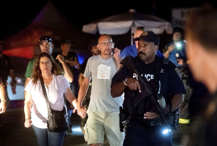 Police officers escort people from Christmas Hill Park following a deadly shooting during the Gilroy Garlic Festival, in Gilroy, Calif., on Sunday, July 28, 2019. (AP/Noah Berger)