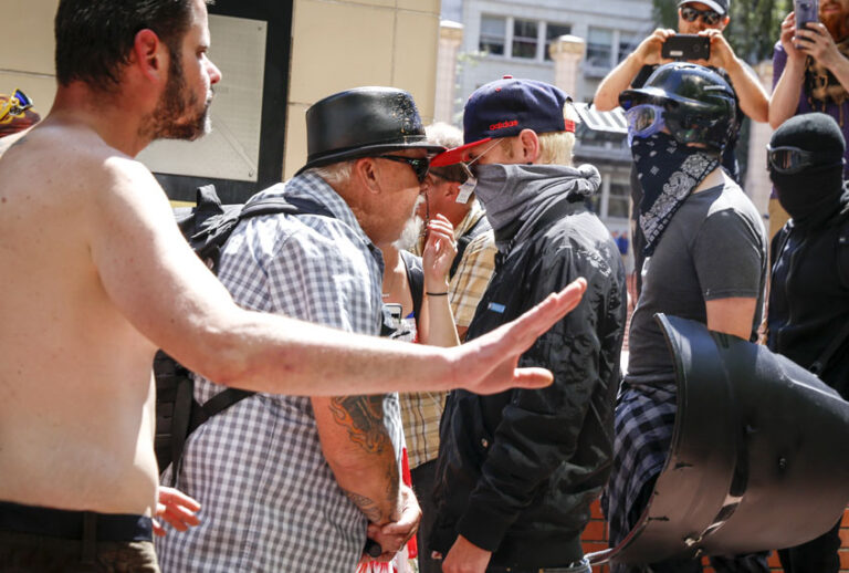An unidentified right aligning man faces off with Rose City Antifa members at Pioneer Courthouse Square on June 29, 2019 in Portland, Oregon. (Getty/Moriah Ratner)