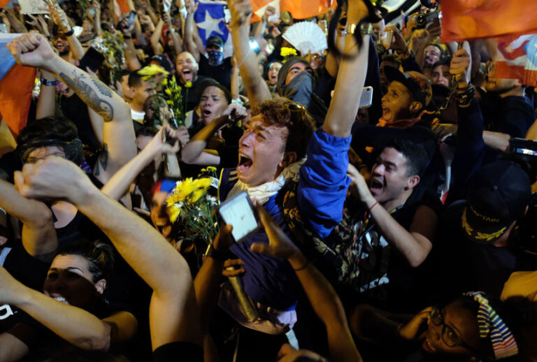 Demonstrators celebrate after the resignation message of the governor of Puerto Rico, Ricardo Rossello in front his mansion known as La Fortaleza in San Juan, on July 24, 2019. (Getty/Ricardo ARDUENGO)