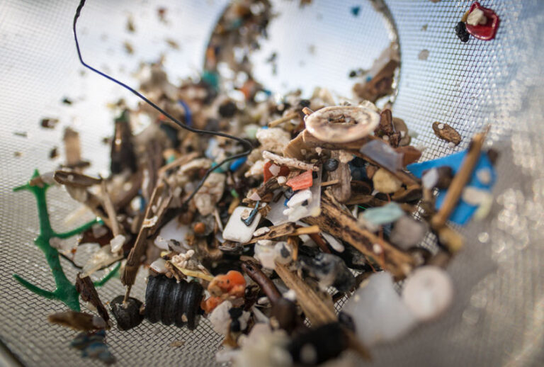 A volunteer of the NGO 'Canarias Libre de Plasticos' (Canary Islands free of plastics) carries out a collection of microplastics and mesoplastic debris to clean the Almaciga Beach, on the north coast of the Canary Island of Tenerife, on July 14, 2018. (Getty/DESIREE MARTIN)