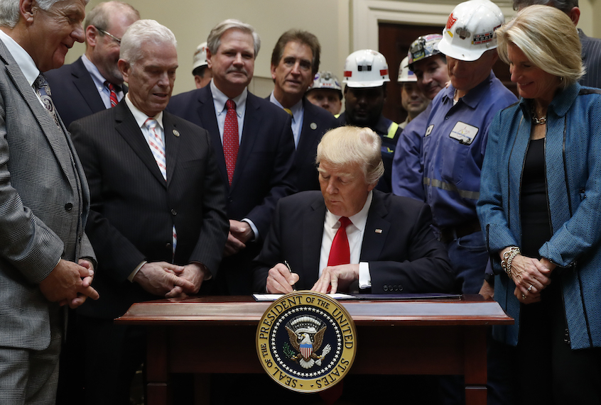 President Donald Trump signs H.J. Res. 38 in the Roosevelt Room of the White House in White House in Washington, Thursday, Feb. 16, 2017. (AP Photo/Carolyn Kaster)