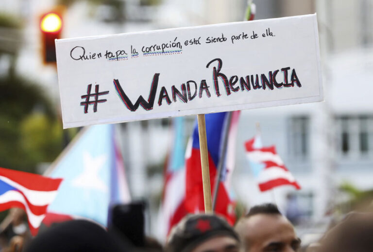 People demand the resignation of Justice Secretary Wanda Vazquez during a protest outside the Department of Justice in San Juan, Puerto Rico, Monday, July 29, 2019. (AP/Brandon Cruz González)
