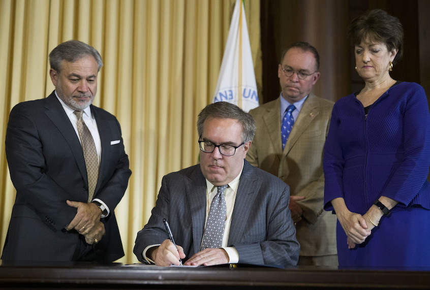 Deputy Secretary of Energy Dan Brouillette, left, Acting White House Chief of Staff Mick Mulvaney, and Chairman of the Council on Environmental Quality (CEQ) Mary B. Neumayr, stand as EPA administrator Andrew Wheeler signs the Affordable Clean Energy Rule during a media availability at the Environmental Protection Agency, Wednesday, June 19, 2019, in Washington. (AP Photo/Alex Brandon)