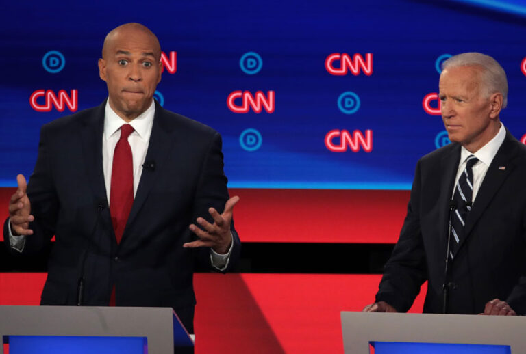 Democratic presidential candidate Sen. Cory Booker (D-NJ) (L) speaks while former Vice President Joe Biden listens during the Democratic Presidential Debate at the Fox Theatre July 31, 2019 in Detroit, Michigan (Getty/Scott Olson)