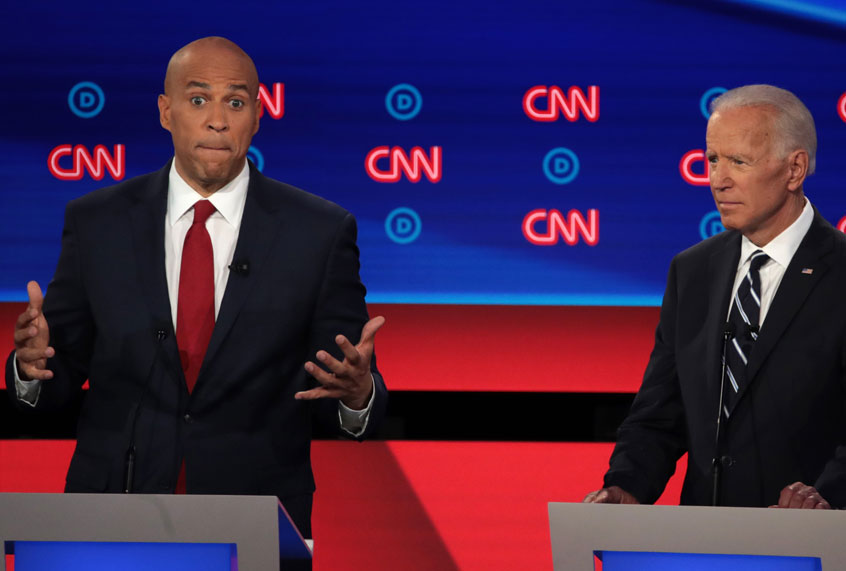 Democratic presidential candidate Sen. Cory Booker (D-NJ) (L) speaks while former Vice President Joe Biden listens during the Democratic Presidential Debate at the Fox Theatre July 31, 2019 in Detroit, Michigan (Getty/Scott Olson)