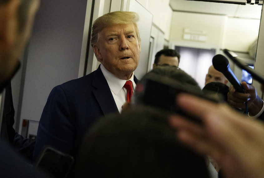 President Donald Trump talks to reporters aboard Air Force One after visiting Dayton, Ohio and El Paso, Texas, Wednesday, Aug. 7, 2019. (AP/Evan Vucci)
