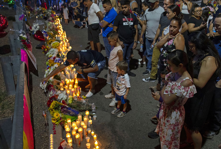 People gather at makeshift memorial for the victims of Saturday's mass shooting at a shopping complex in El Paso, Texas, Sunday, Aug. 4, 2019. (AP/Andres Leighton)