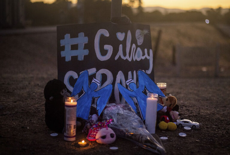 Candles burn at a makeshift memorial for Gilroy Garlic Festival shooting victims outside the festival grounds, Monday, July 29, 2019, in Gilroy, Calif. (AP/Noah Berger)