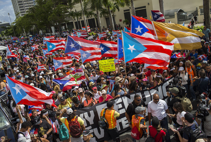 People gather to celebrate the resignation of Gov. Ricardo Rossello who announced that he is resigning Aug. 2 after weeks of protests in San Juan, Puerto Rico, Thursday, July 25, 2019. (AP Photo/Dennis M. Rivera Pichardo) (AP Photo/Dennis M. Rivera Pichardo)