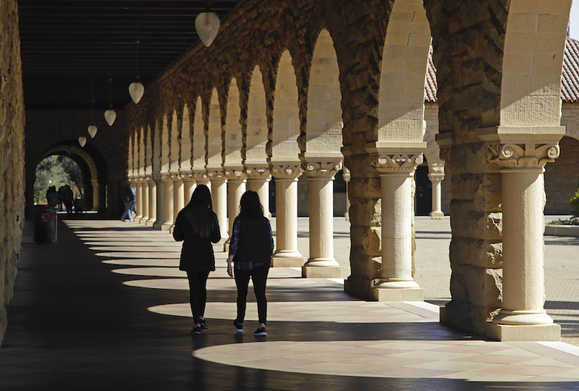 FILE - In this March 14, 2019, file photo students walk on the Stanford University campus in Stanford, Calif. (AP Photo/Ben Margot, File)