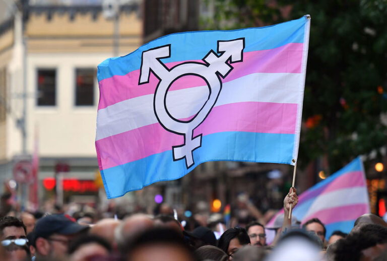 A person holds a transgender pride flag as people gather on Christopher Street outside the Stonewall Inn for a rally to mark the 50th anniversary of the Stonewall Riots in New York, June 28, 2019. (Getty Images/Angela Weiss)