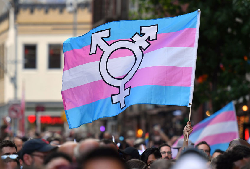 A person holds a transgender pride flag as people gather on Christopher Street outside the Stonewall Inn for a rally to mark the 50th anniversary of the Stonewall Riots in New York, June 28, 2019. (Getty Images/Angela Weiss)